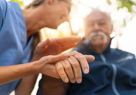 end of life doula caring for elderly man outdoors