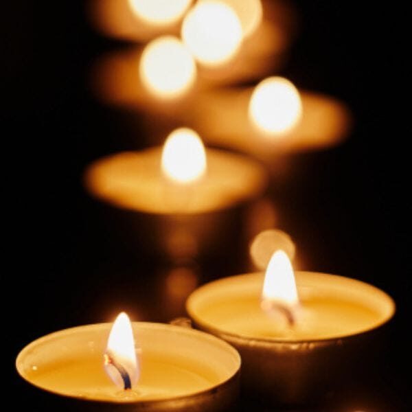 Candles burning while sitting vigil by bedside of dying person